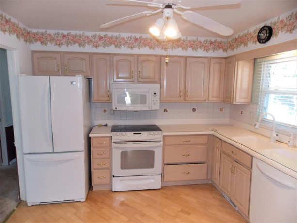 bleached-oak-kitchen-cabinets-all-appliances-and-corian-counter-tops-big-4