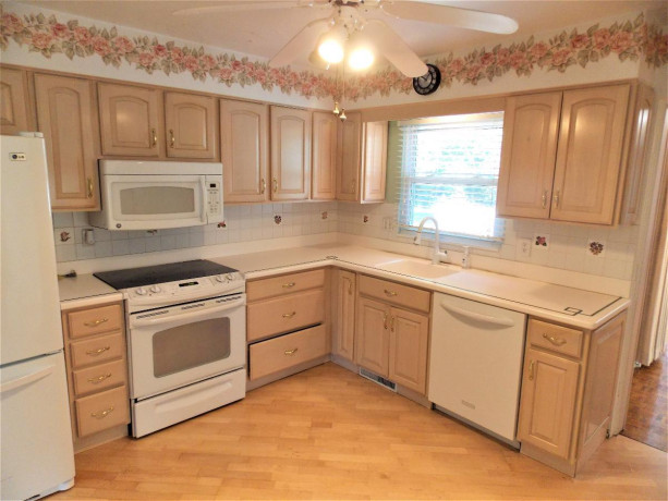 bleached-oak-kitchen-cabinets-all-appliances-and-corian-counter-tops-big-3