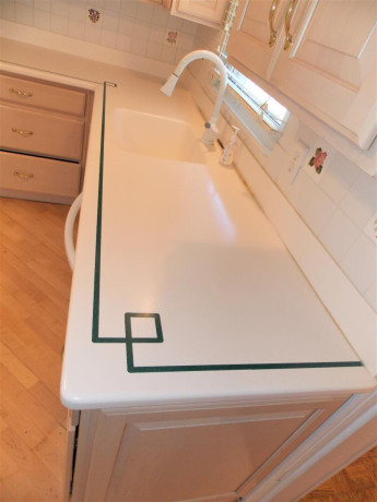 bleached-oak-kitchen-cabinets-all-appliances-and-corian-counter-tops-big-0