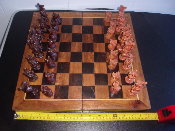 vintage-chess-board-with-jungle-animal-pieces-and-regular-wooden-pieces-amazing-big-0