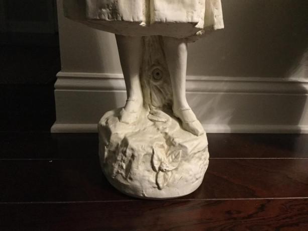 statue-of-young-girl-on-a-rock-holding-a-key-big-0