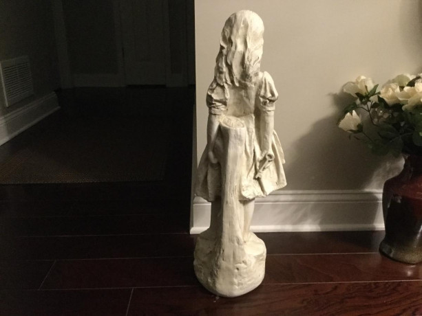 statue-of-young-girl-on-a-rock-holding-a-key-big-2